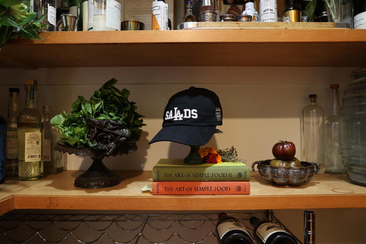Black Baseball hat with "SaLAds" embroidered in white on the front. 